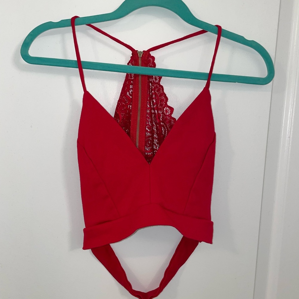 Red plunge neck crop top with open lace back.